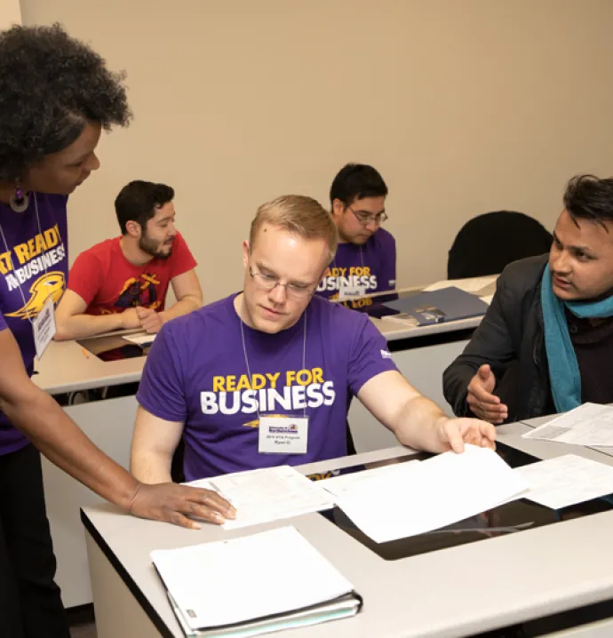 UNI accounting professor Cathy Bowler assists students during the annual VITA program