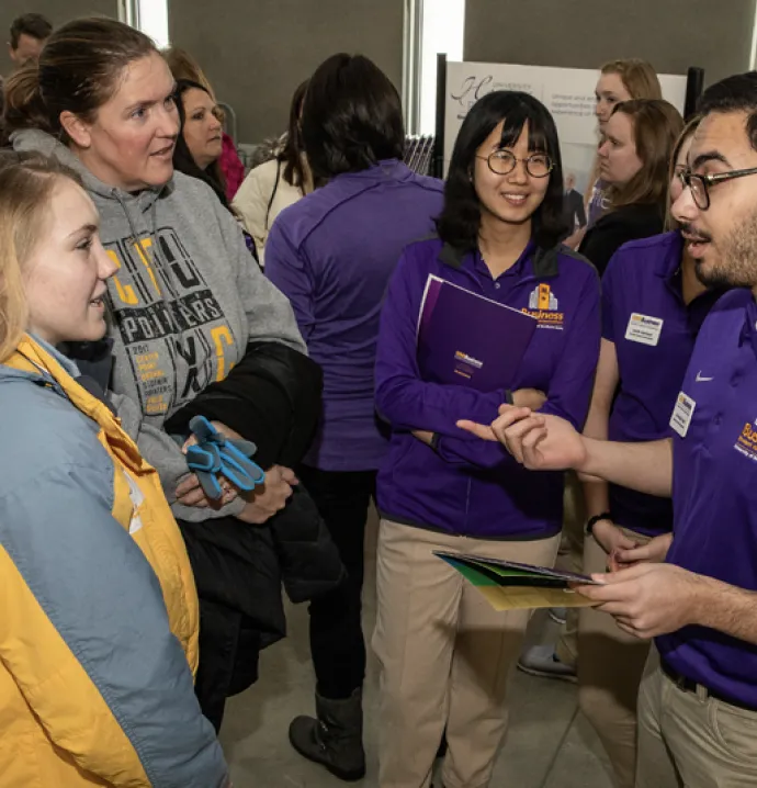 University of Northern Iowa business students chat with prospective students