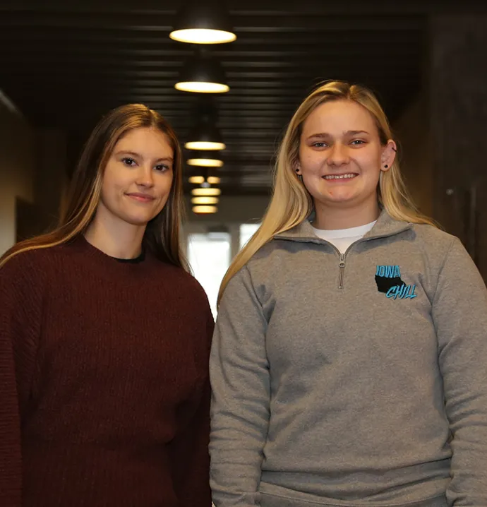Emma Criswell and Hanna Saland standing in the hallway of UNI’s John Pappajohn Entrepreneurial Center