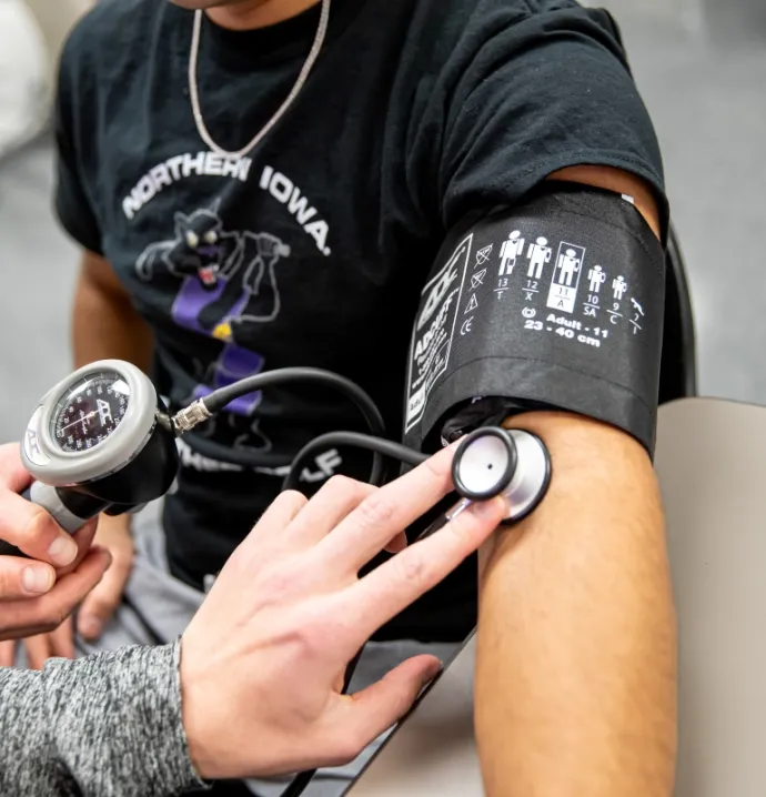 Student wearing blood pressure cuff
