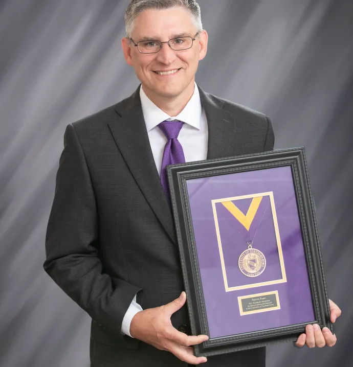 Patrick Pease holding his Presidential Medallion
