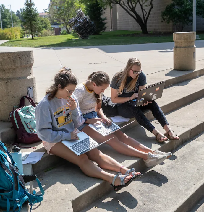 Students doing homework outside
