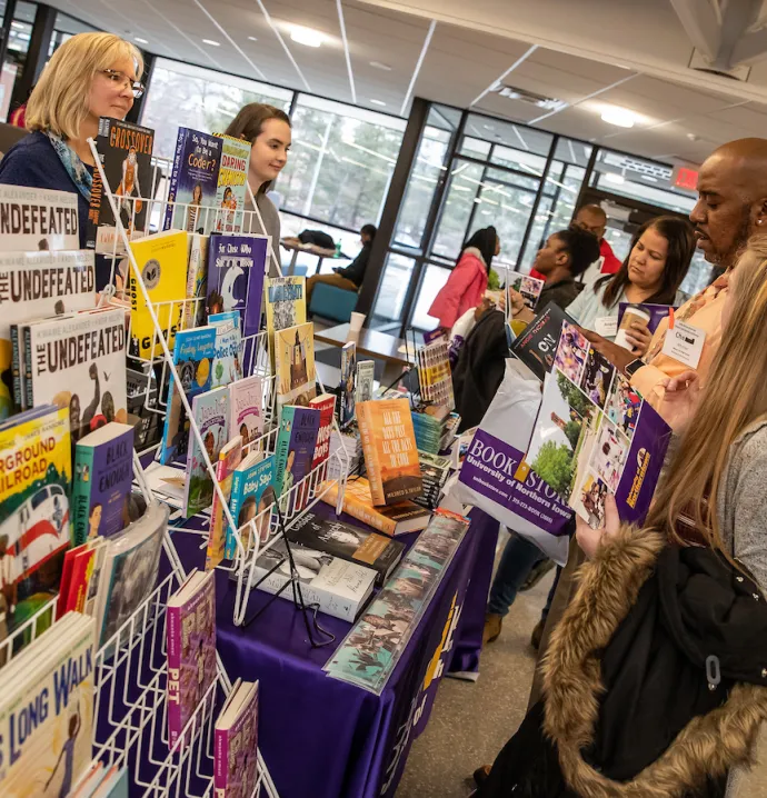 Families browse children's books at 9th African American Children and Families Conference