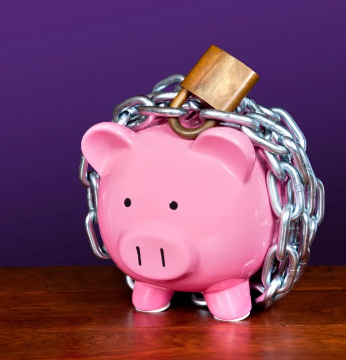 Piggy bank wrapped in chains with padlock