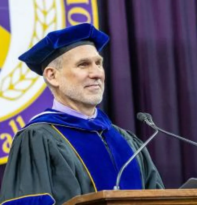 Provost and Executive Vice President Jim Wohlpart stands at the podium during commencement.