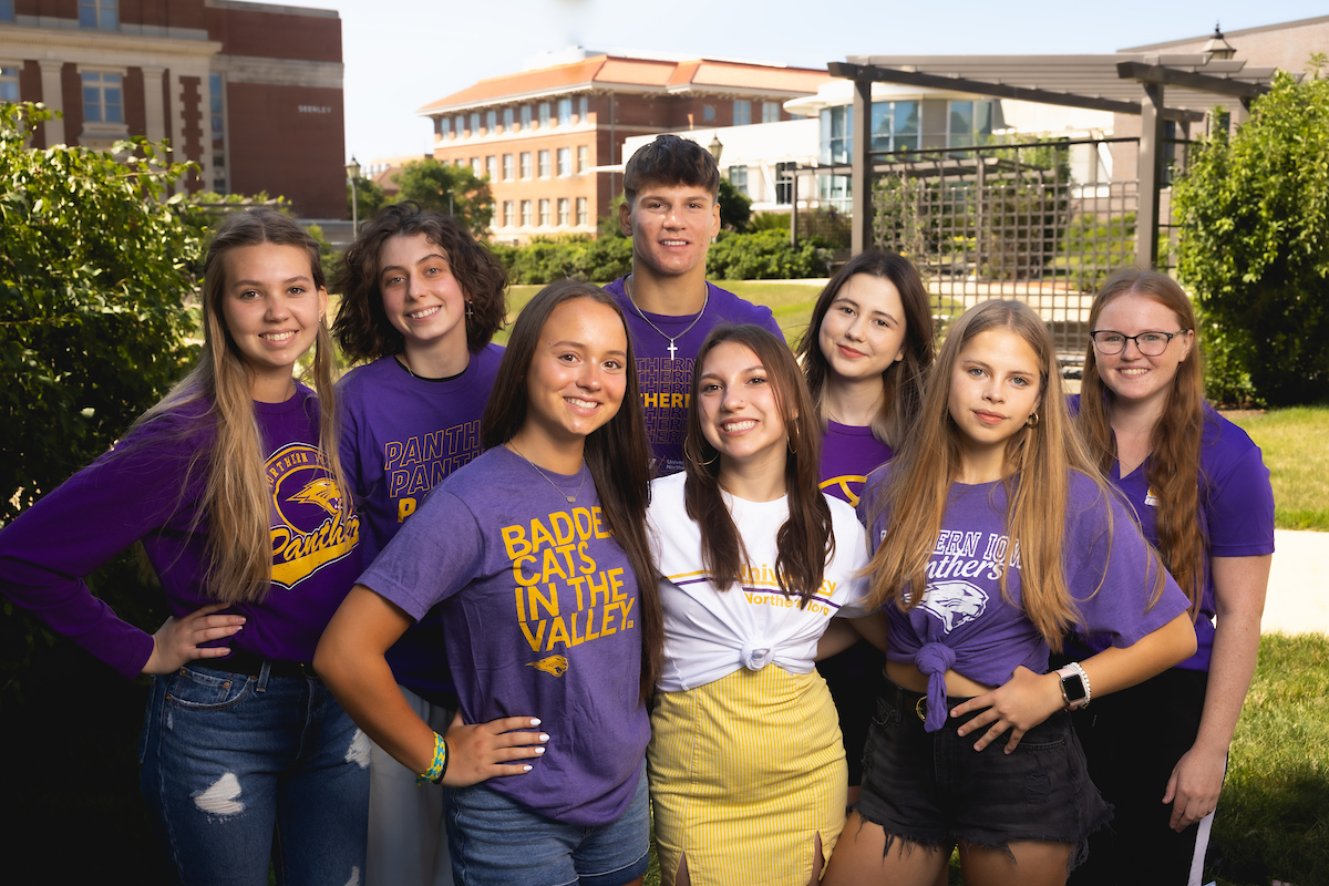 Eight Ukrainian students on UNI campus wearing Panther gear