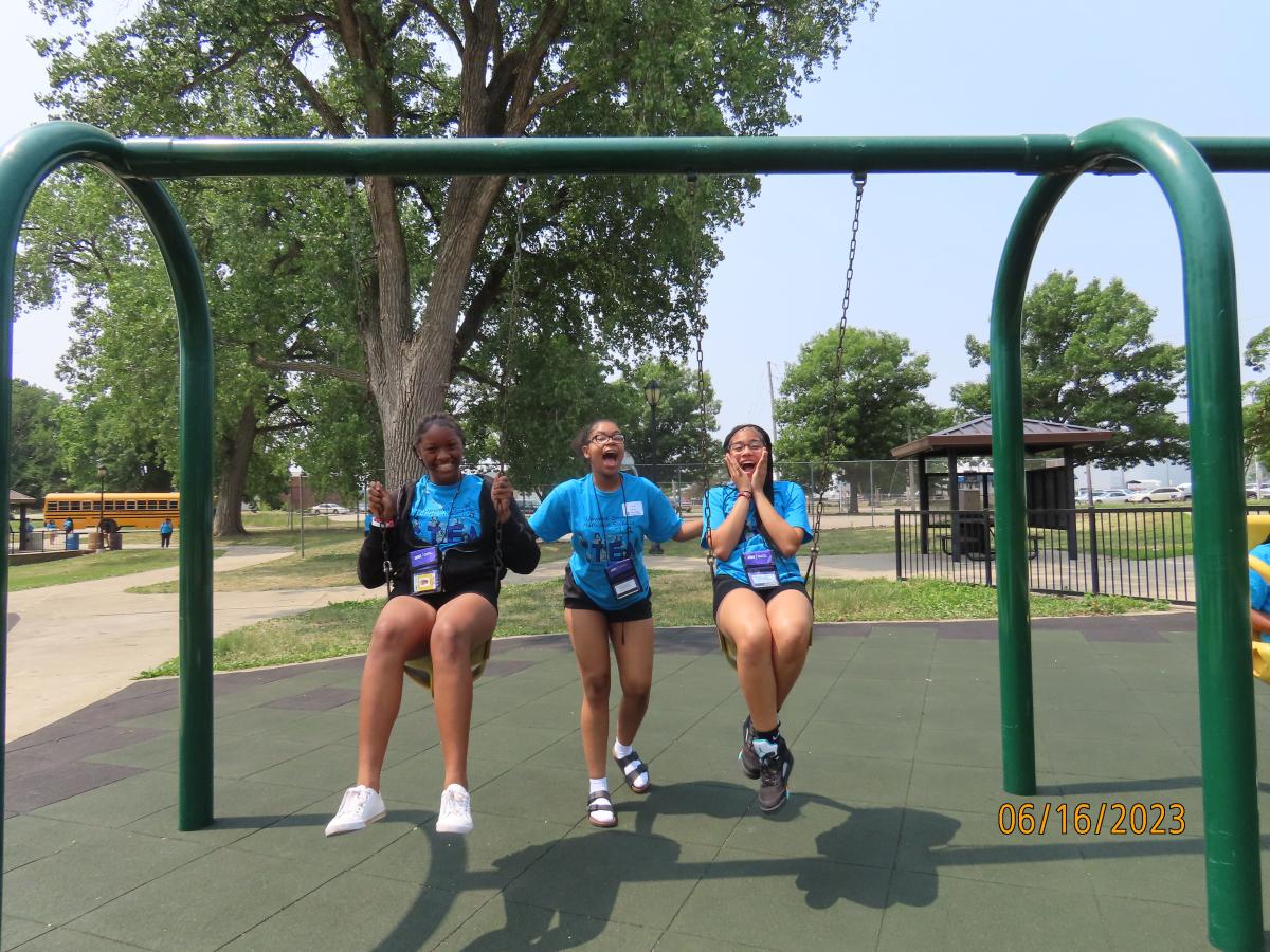 Upward Bound Math and Science students playing on a swingset